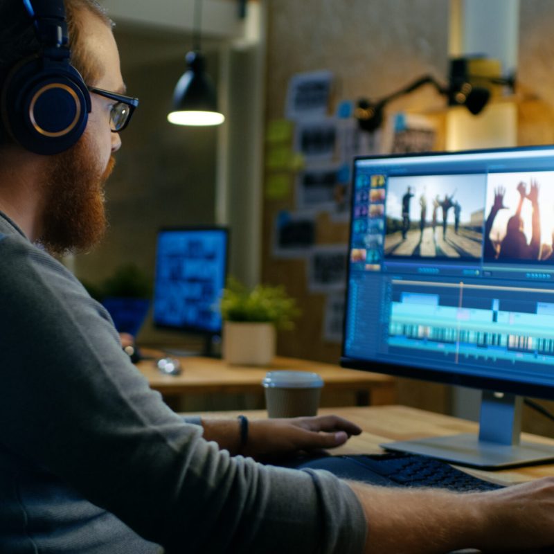 Male,Videographer,Edits,And,Cuts,Footage,And,Sound,On,His Male,Videographer,Edits,And,Cuts,Footage,And,Sound,On,His